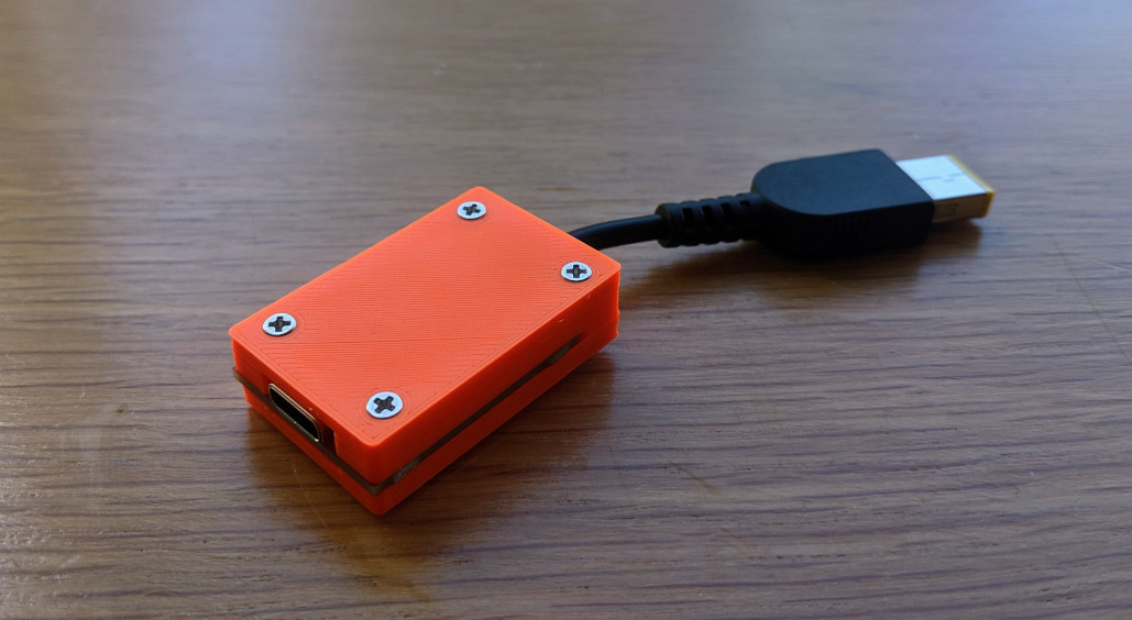 Thinkpad adapter with 3D printed orange case