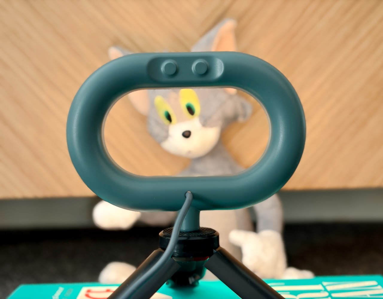 Rear of an IKEA STÄNKREGN LED ring lamp on a camera tripod with a Tom plush toy behind it