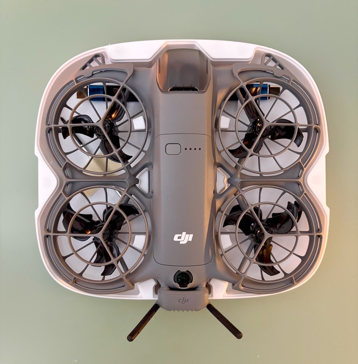 DJI Neo 2 nested inside the white bottom half of its 3D-printed case