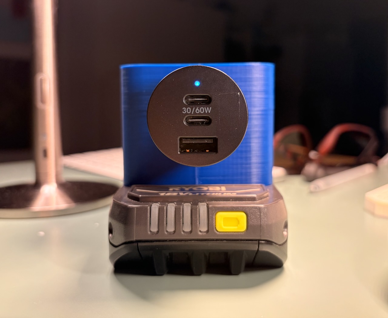 USB-C car charger plugged into a Ryobi 18V battery cigarette lighter adapter
